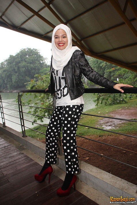 Dewi Sandra dengan jaket kulit dan celana polkadot. Image via KapanLagi.com